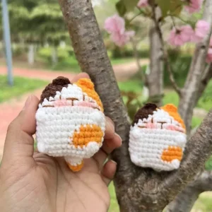 Handmade crochet calico cat miniature kitten plush in tri-color cotton yarn.